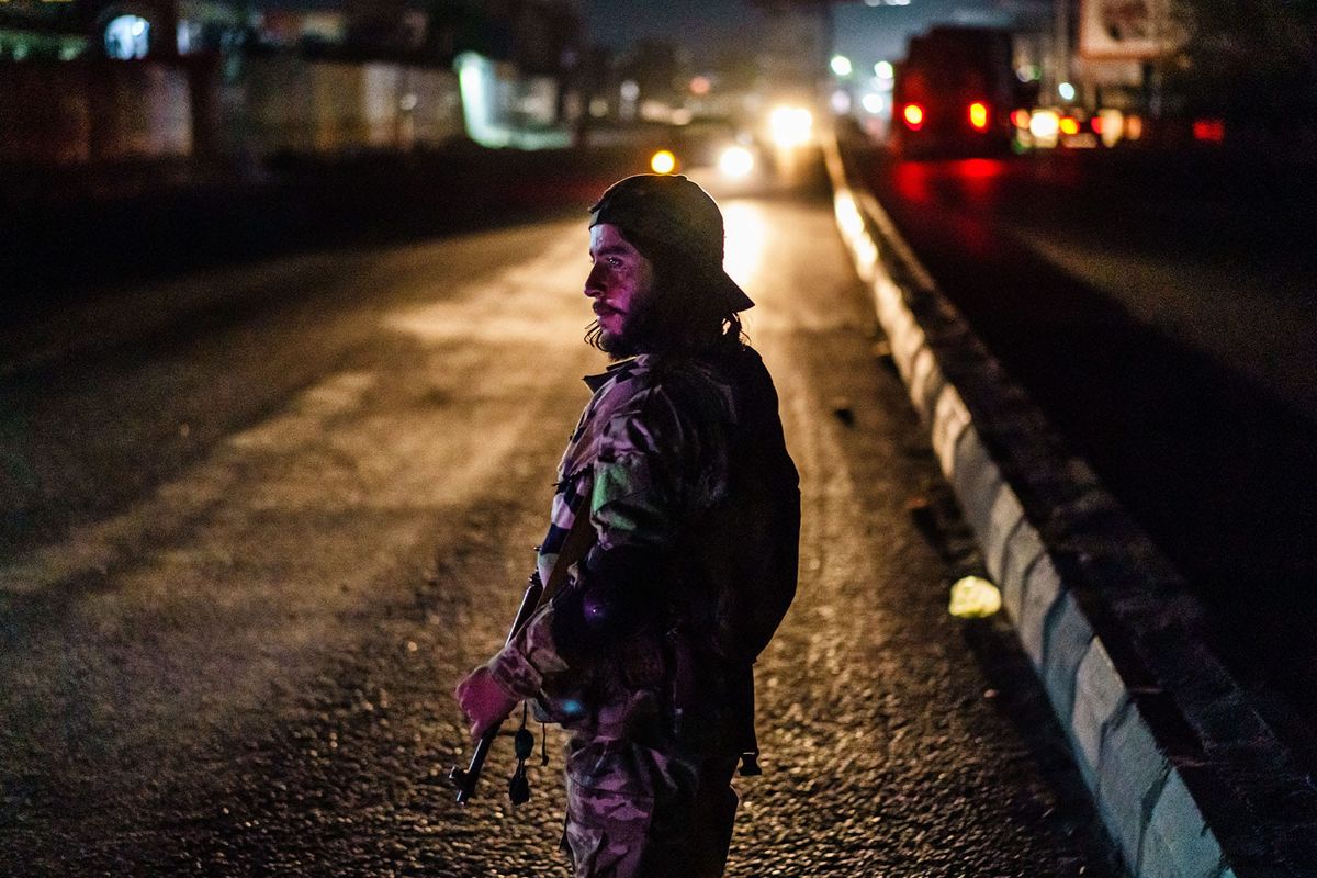 Photo of a Taliban fighter standing with a weapon at a check point in Afghanistan