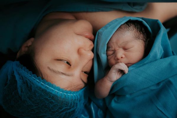 A mother looking at her newborn baby