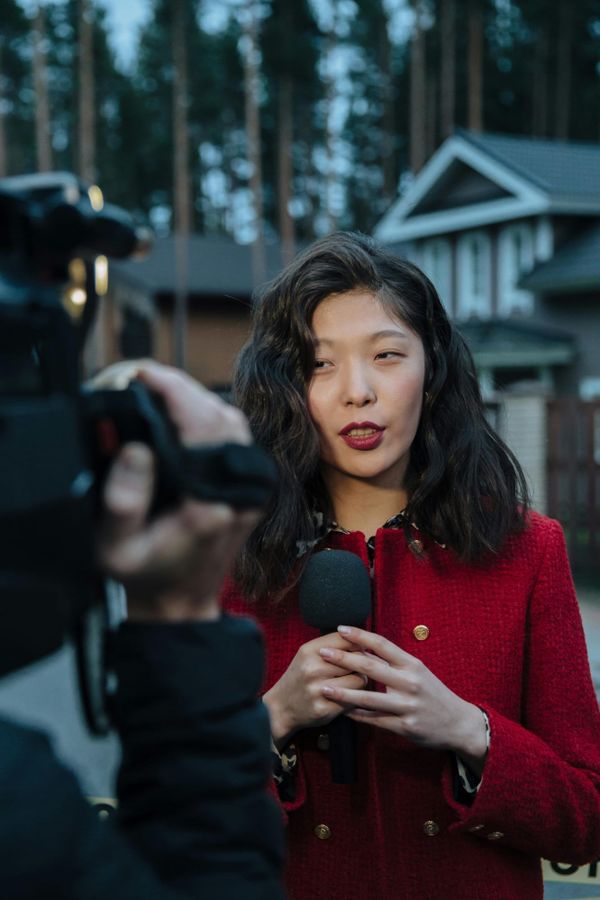 A reporter holding a microphone during an interview