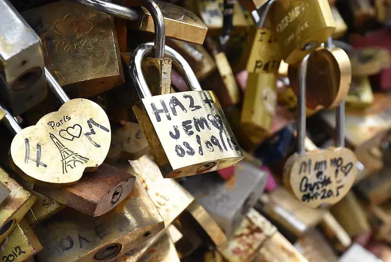 Love padlocks clipped to a Paris bridge, evoking trust and secure connections