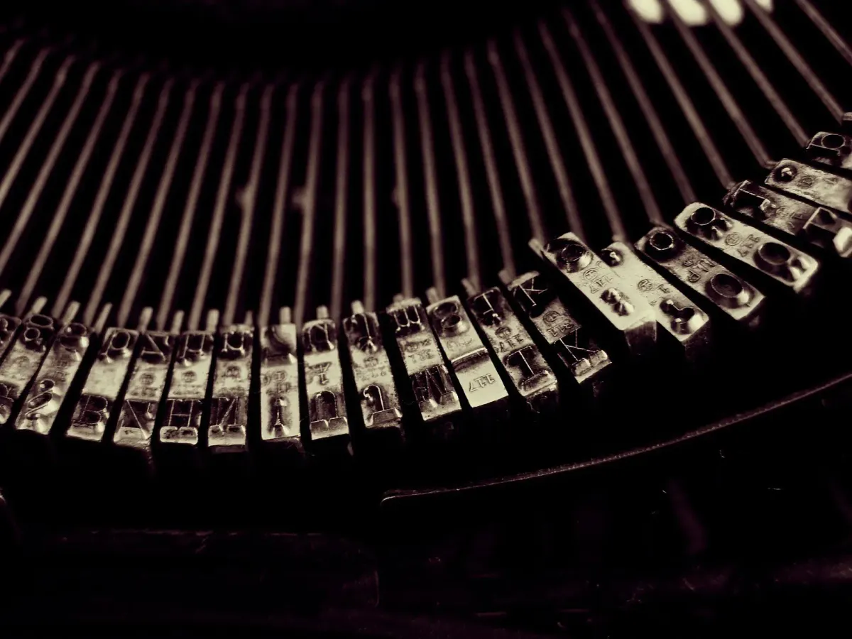 Close-up of a vintage typewriter's keys, framing the article's invitation to start writing