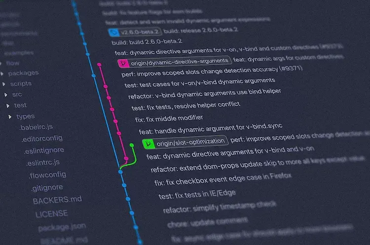 Close-up of a colorful Git commit log in an editor, branches diverging and merging