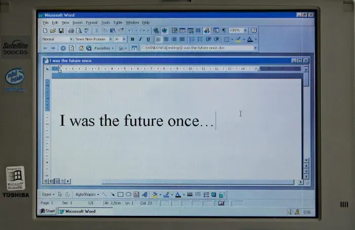 Old Toshiba laptop running Microsoft Word reading 'I was the future once'; aging Office templates.
