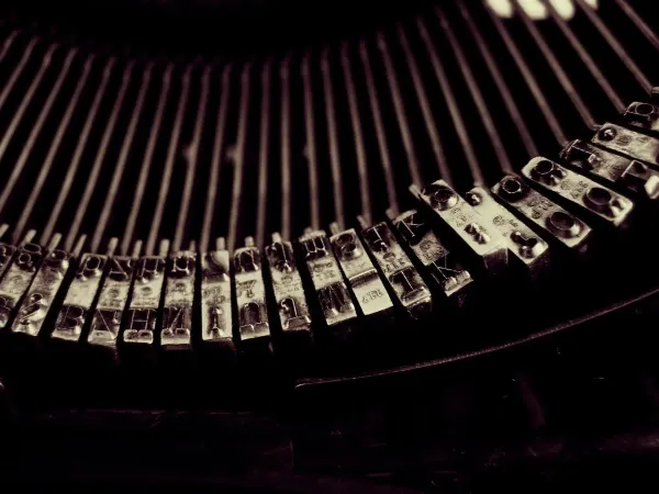 Close-up of a vintage typewriter's keys, framing the article's invitation to start writing