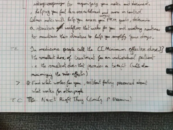 Handwritten notebook page capturing book ideas with tags and references in the margin