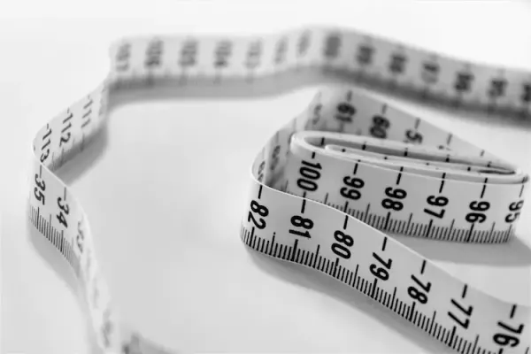 Measuring tape coiled on white background, evoking the measurement of JavaScript bundle size