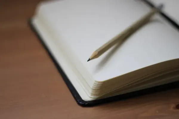 Open blank notebook with pencil, ready to capture every task and commitment at work
