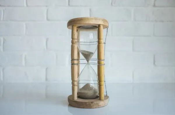 An hourglass wrapped in wire, evoking dates, time validation and the fading Moment.js library.