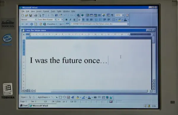 Old Toshiba laptop running Microsoft Word reading 'I was the future once'; aging Office templates.