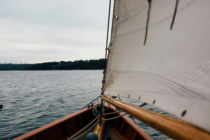 The view from within a sailboat, headed for land.