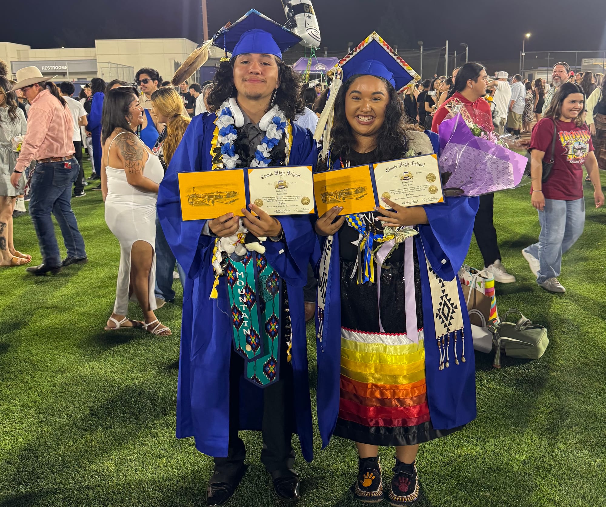 Bella Garcia and a fellow Native American graduate wearing tribal stoles, eagle feathers and other regalia on their 2025 graduation day. Photo courtesy of Bella Garcia.