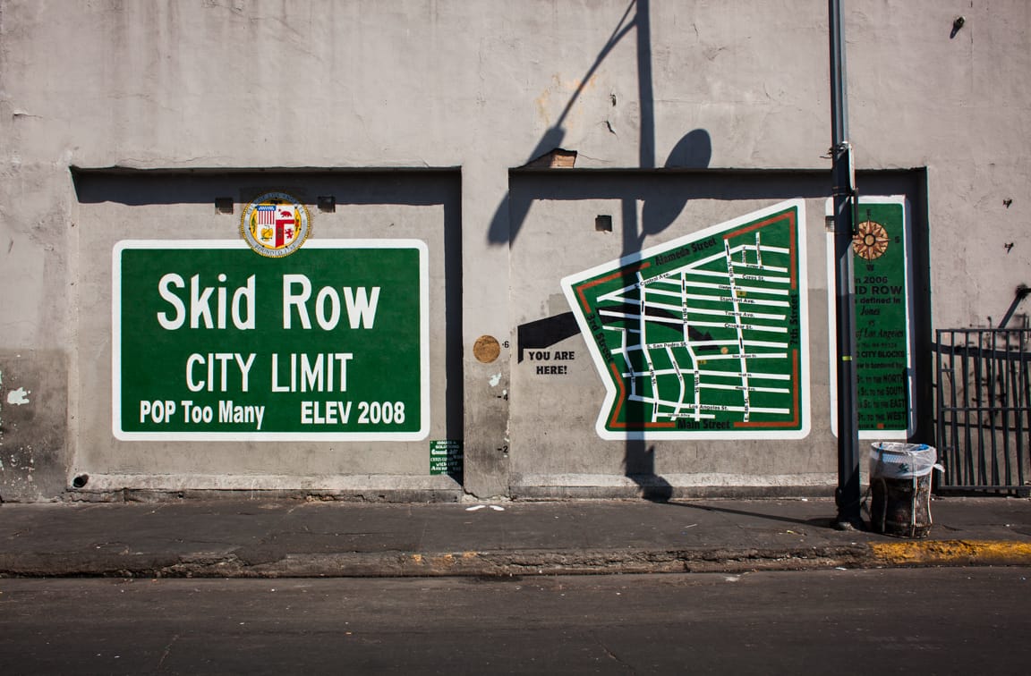 A street mural in downtown Los Angeles that says "Skid Row City Limit, Population Too Many."