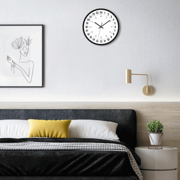 Foxtop 24-hour analog clock above a bed