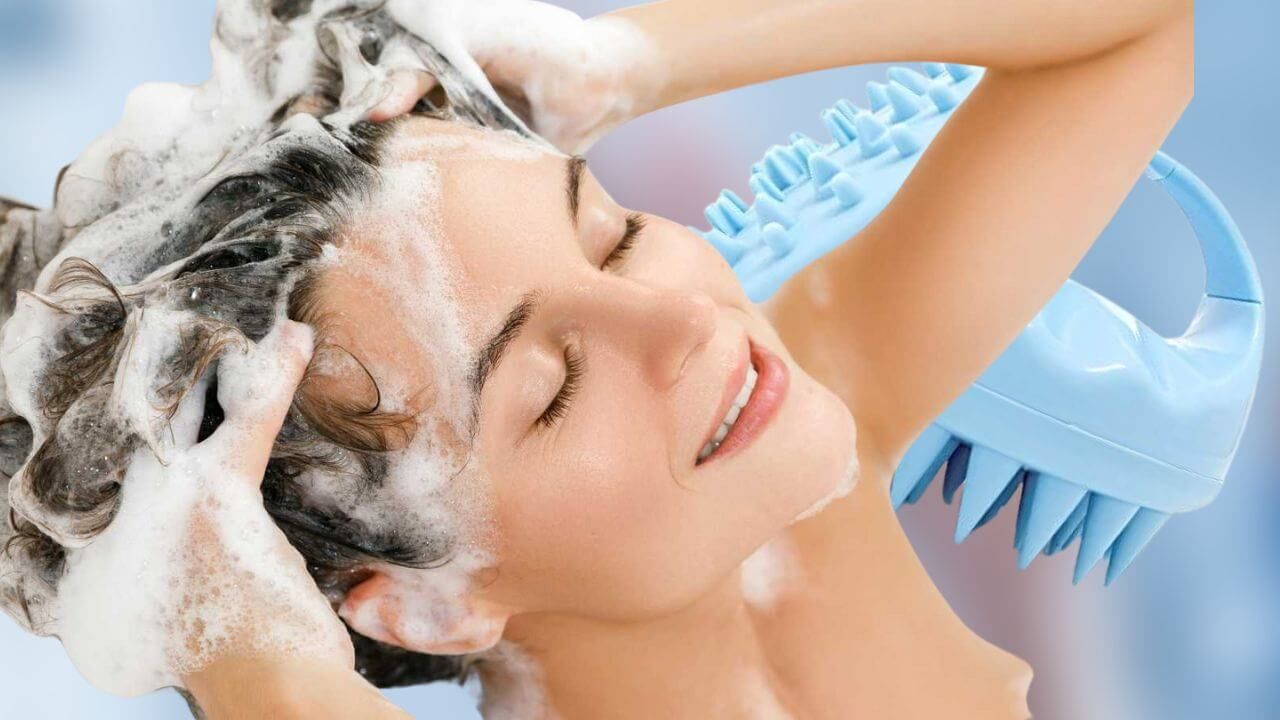 wWoman washing her hair with a scalp scrubber in the background