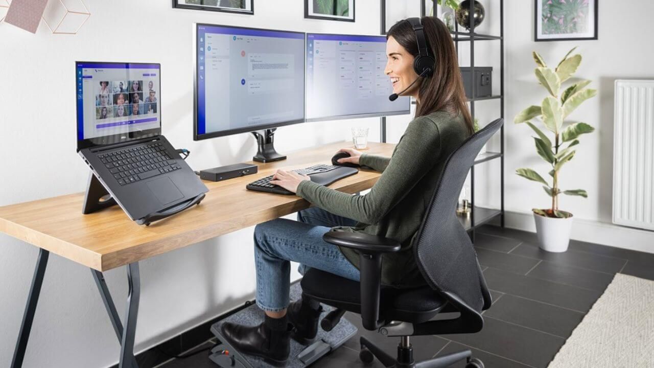 Woman using an ergonomic desk setup for work