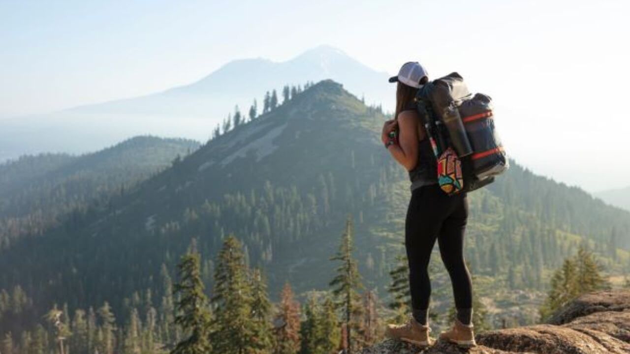 Hiker on a long trek with water in a stainless steel water bottle