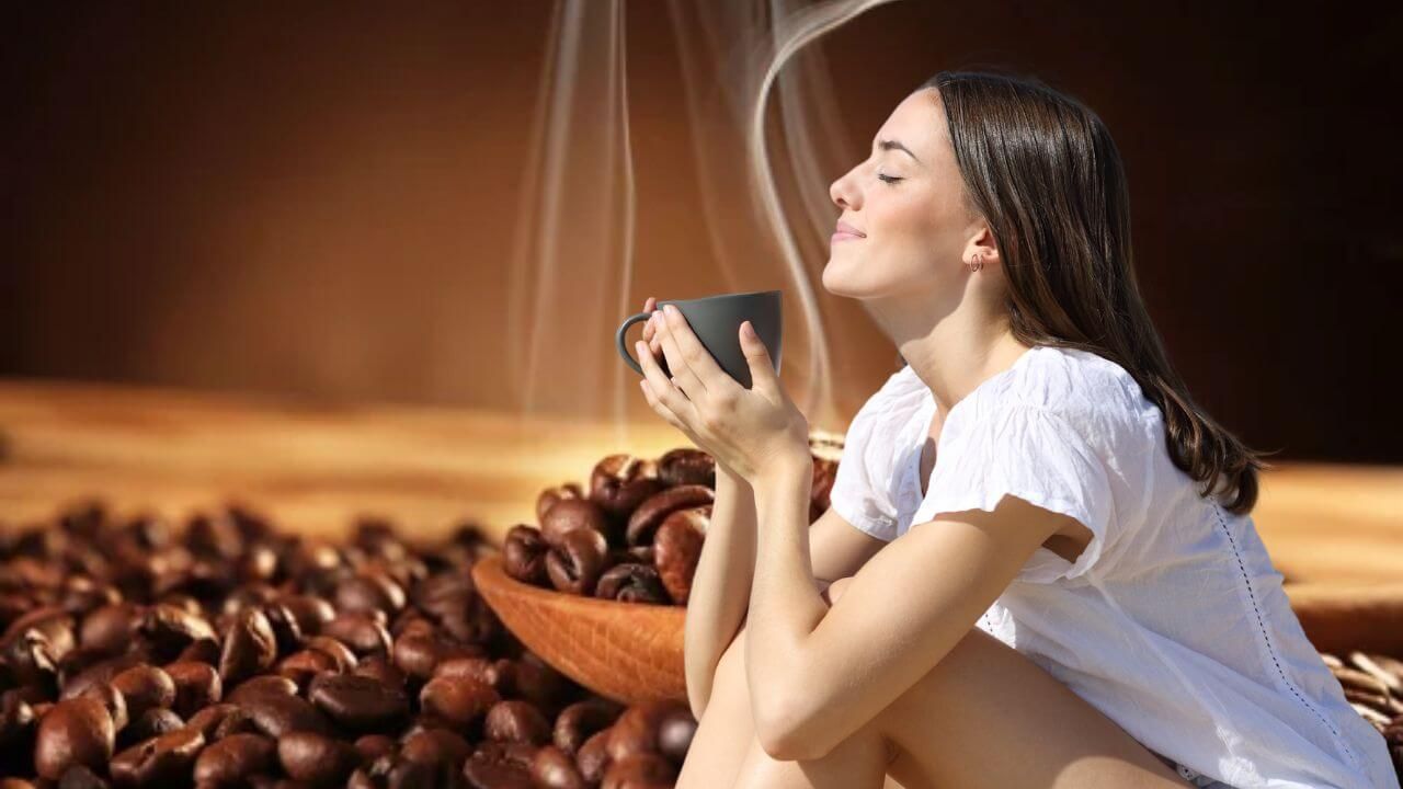 Woman enjoying the aroma of brewed dark roast coffee