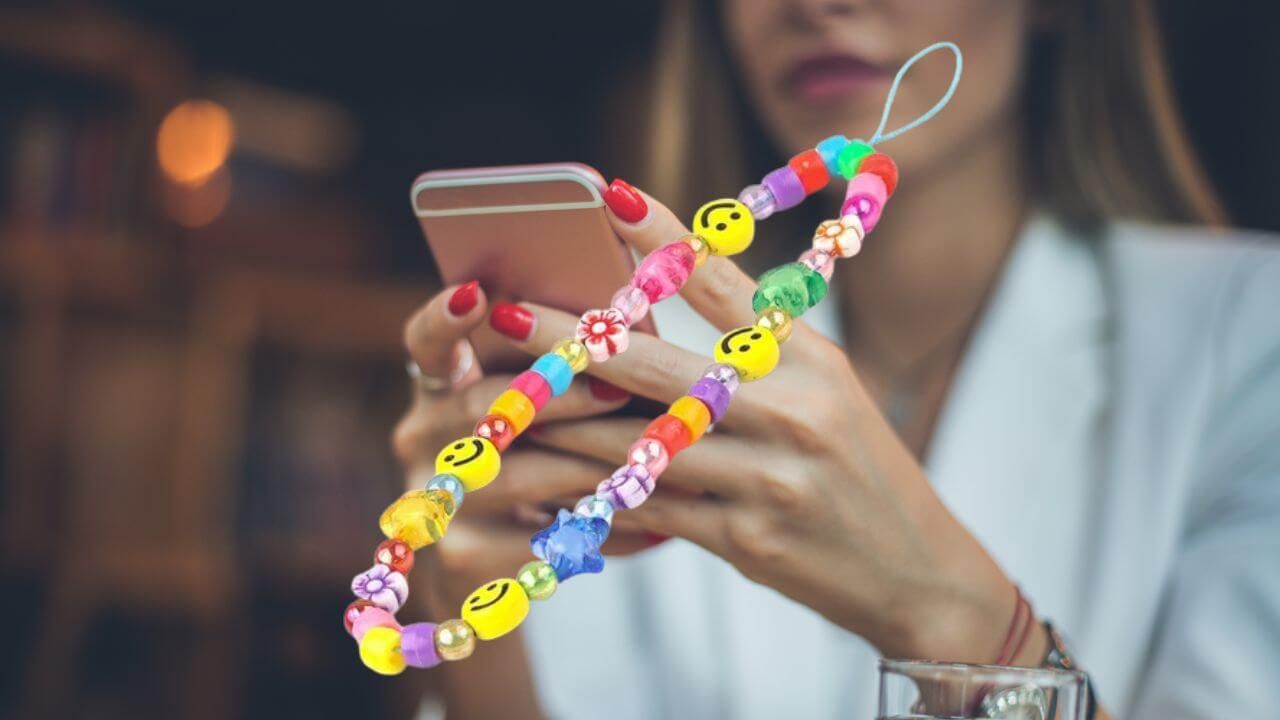 Colorful phone charm strap ready to be attached to a cell phone