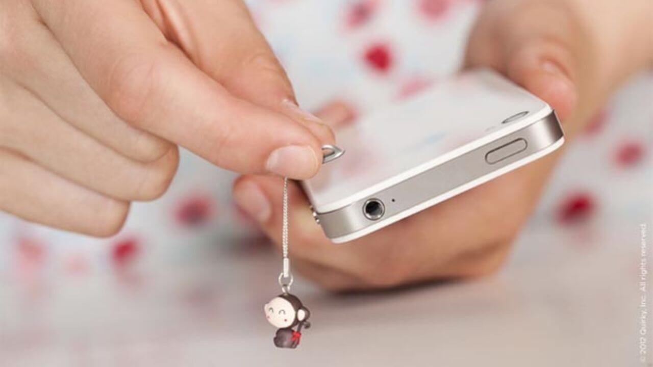 Person attaching a phone charm to a phone