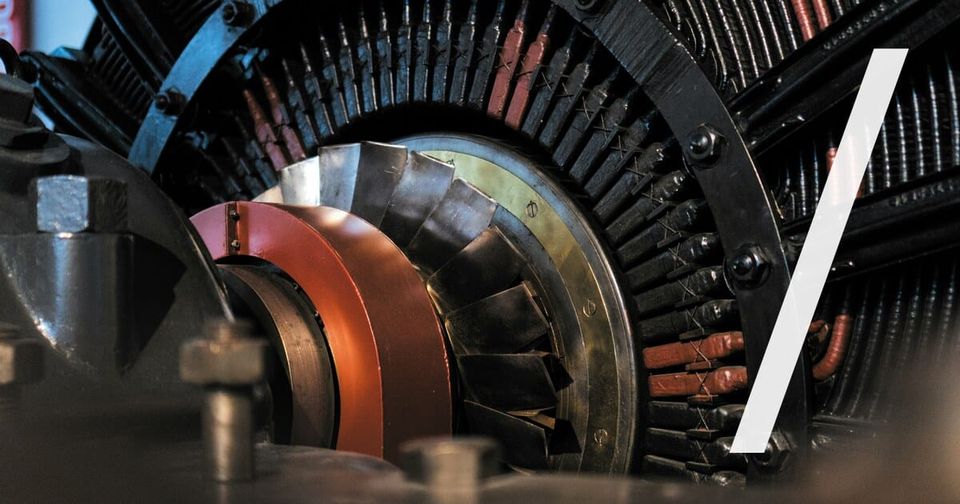 Foto: Nahaufnahme eines zerlegten industriellen Antriebs mit Rotor und farbigen Komponenten. Bruno Mira/Unsplash