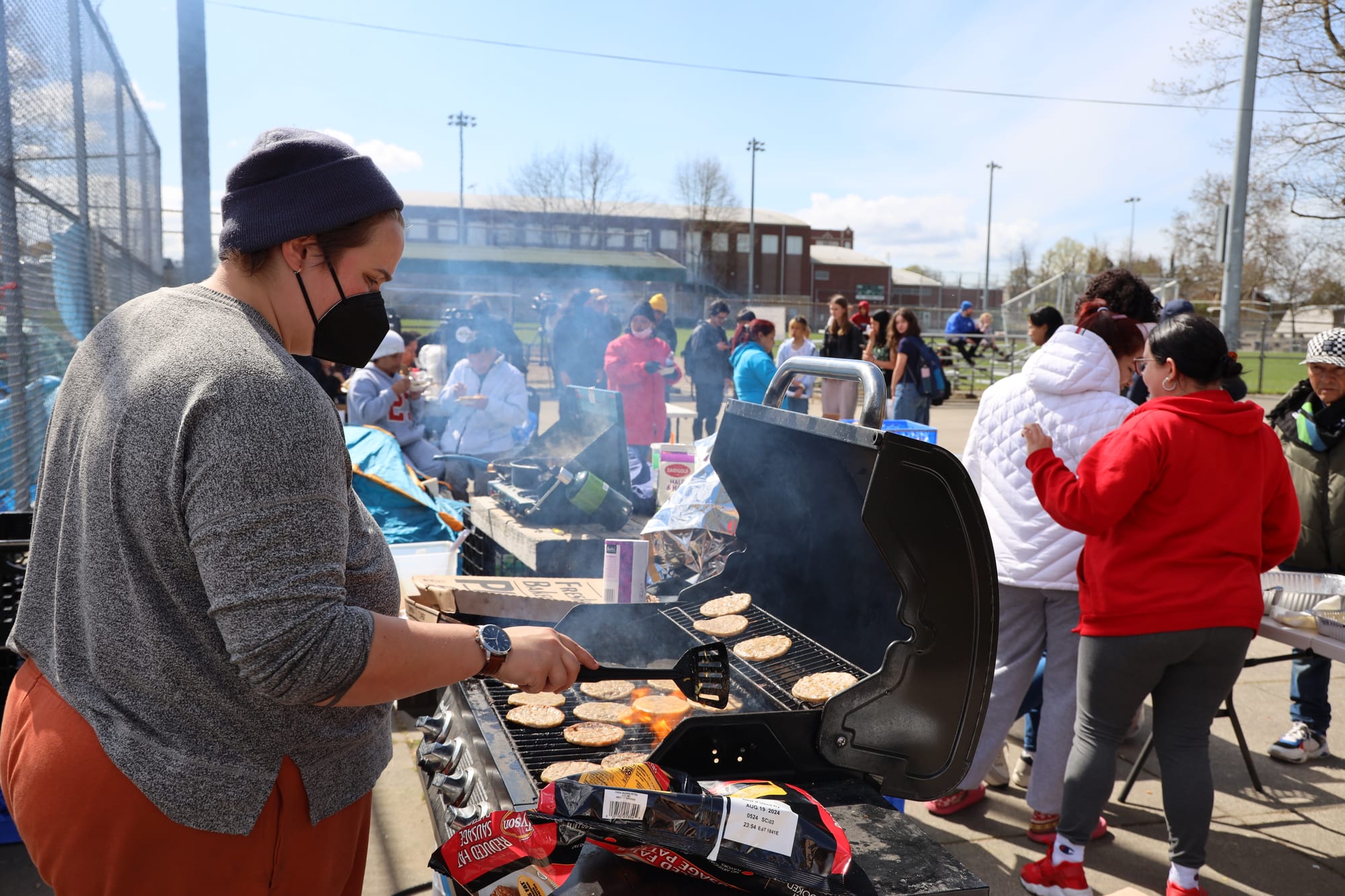 Person grilling hamburgers