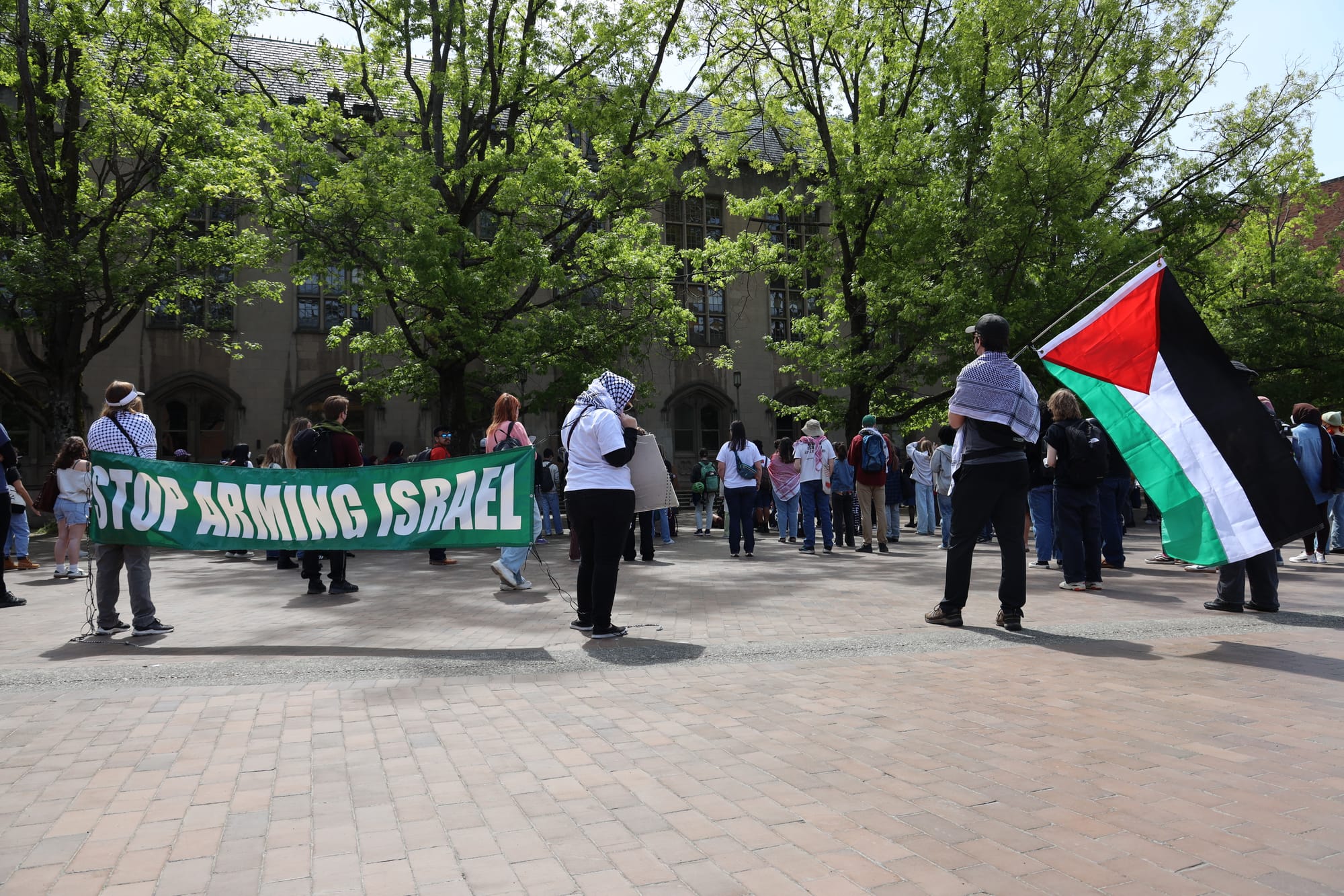 stop arming israel banner and palestine flag