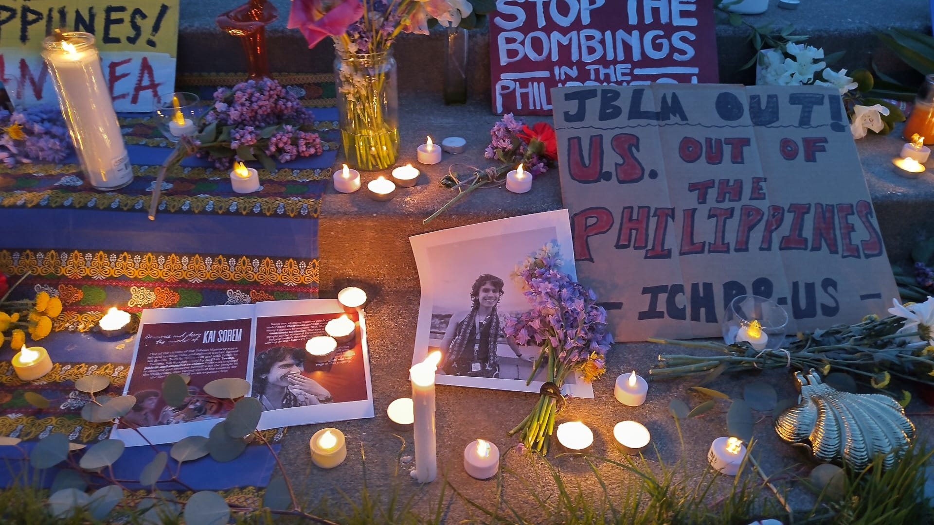 Photo of altar with candles, photos of Kai Sorem and signs