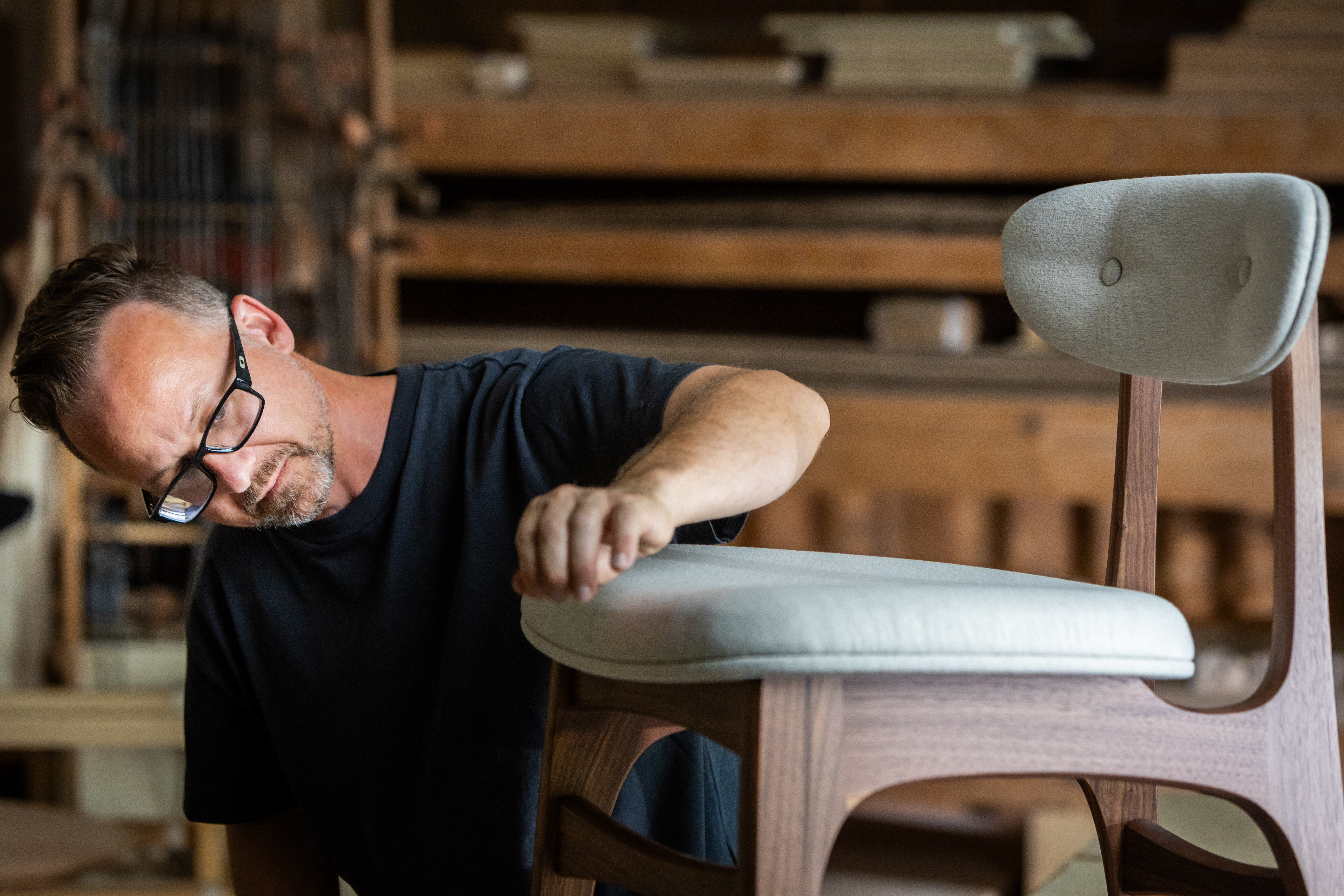 Nathan Hunter inspects a chair.