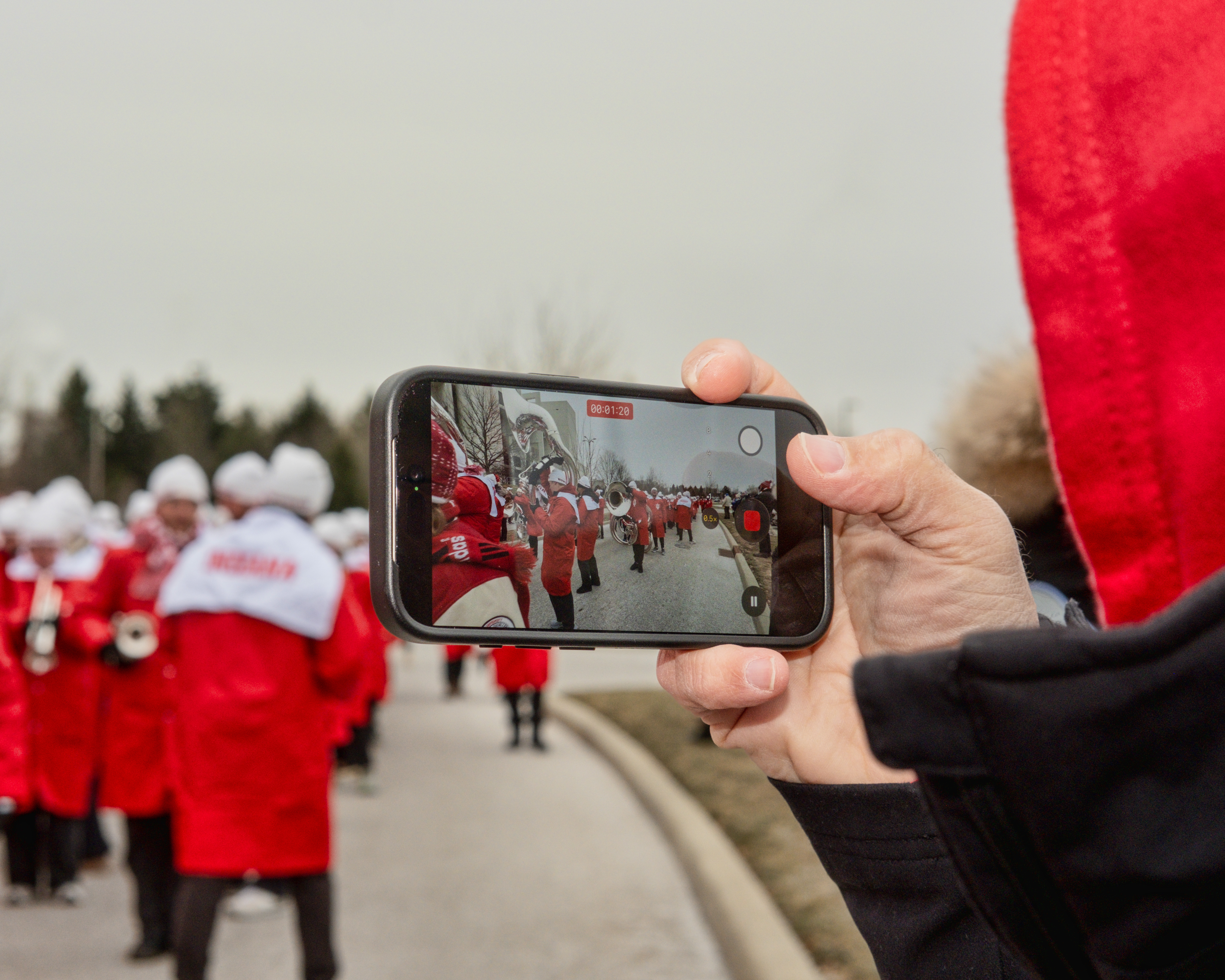 A fan takes pictures of IU's Marching Hundred outside of the stadium. | Photo by Kathryn Coers Rossman