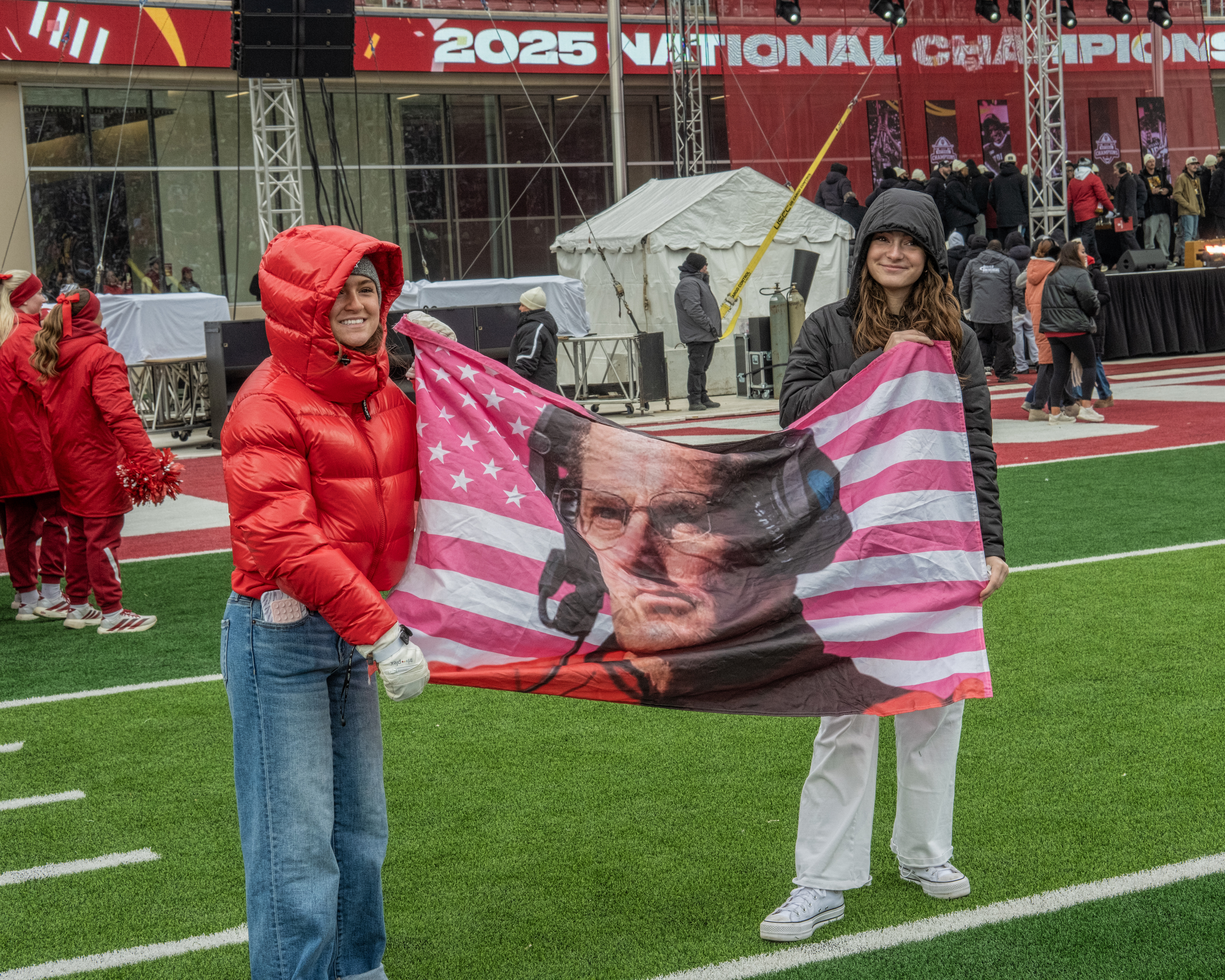 Fans hold up a Coach Curt Cignetti flag. Cignetti's iconic cold stare became an emblem of determination and victory over the course of the football season.