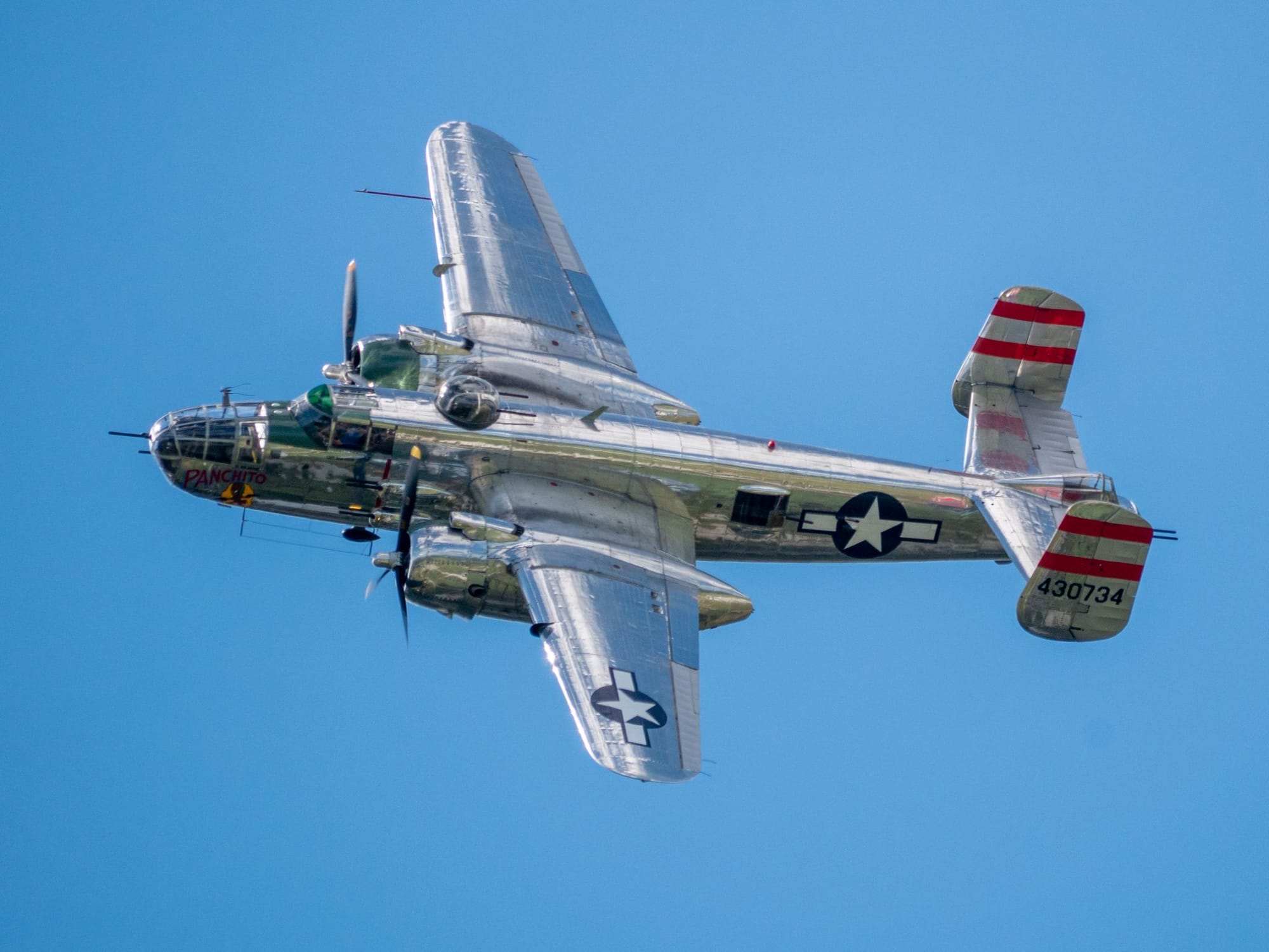 a silver propeller-driven airplane with US Air Force markings on its sides and wings