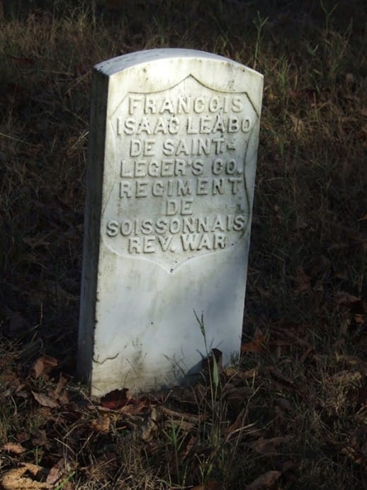 a white gravestone with words FRANCOIS ISAAC LEABO DE SAINT - LEGER'S CO. REGIMENT DE SOISSONNAIS REV. WAR