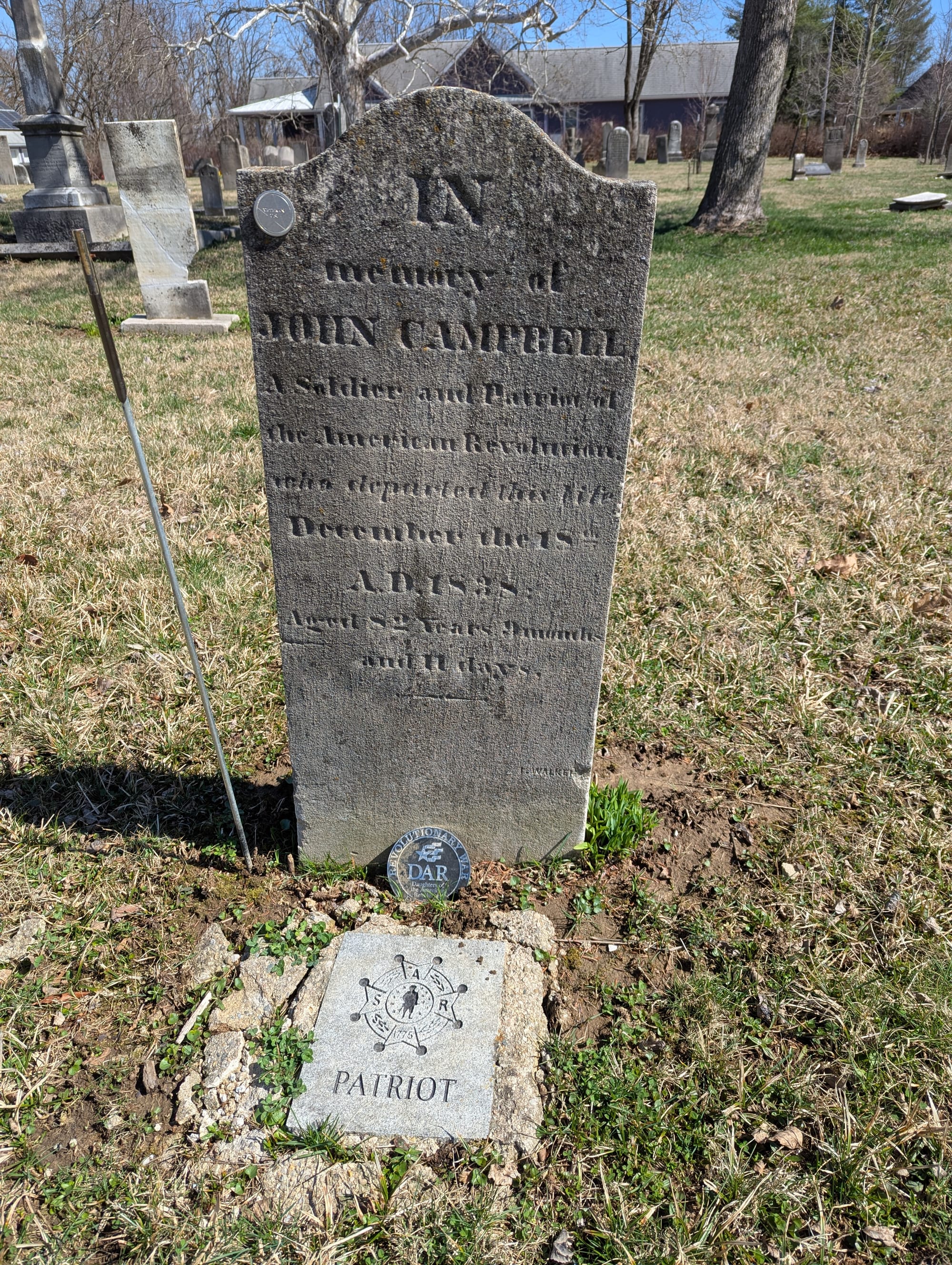 John Campbell's limestone graves marker is weathered and faded