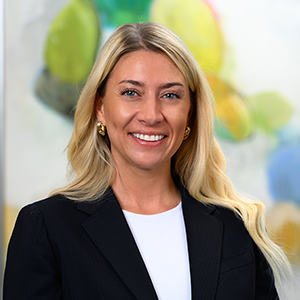 a blonde-haired woman wearing a white shirt and black blazer