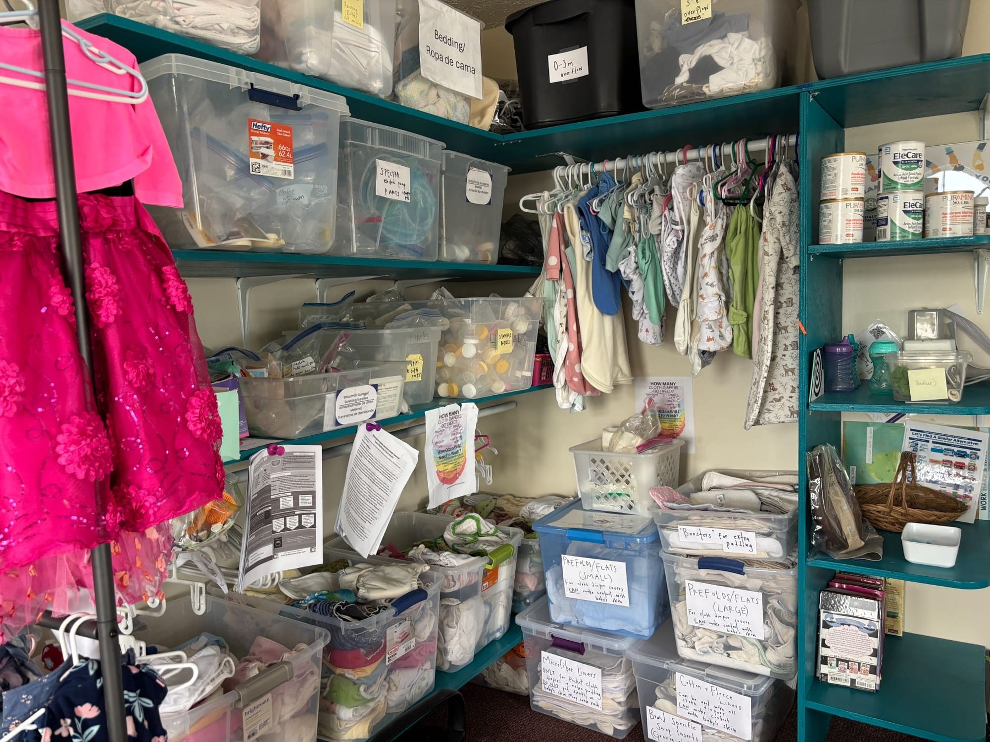 shelves stocked with baby formula, children's clothes, and other resources for parents of young children