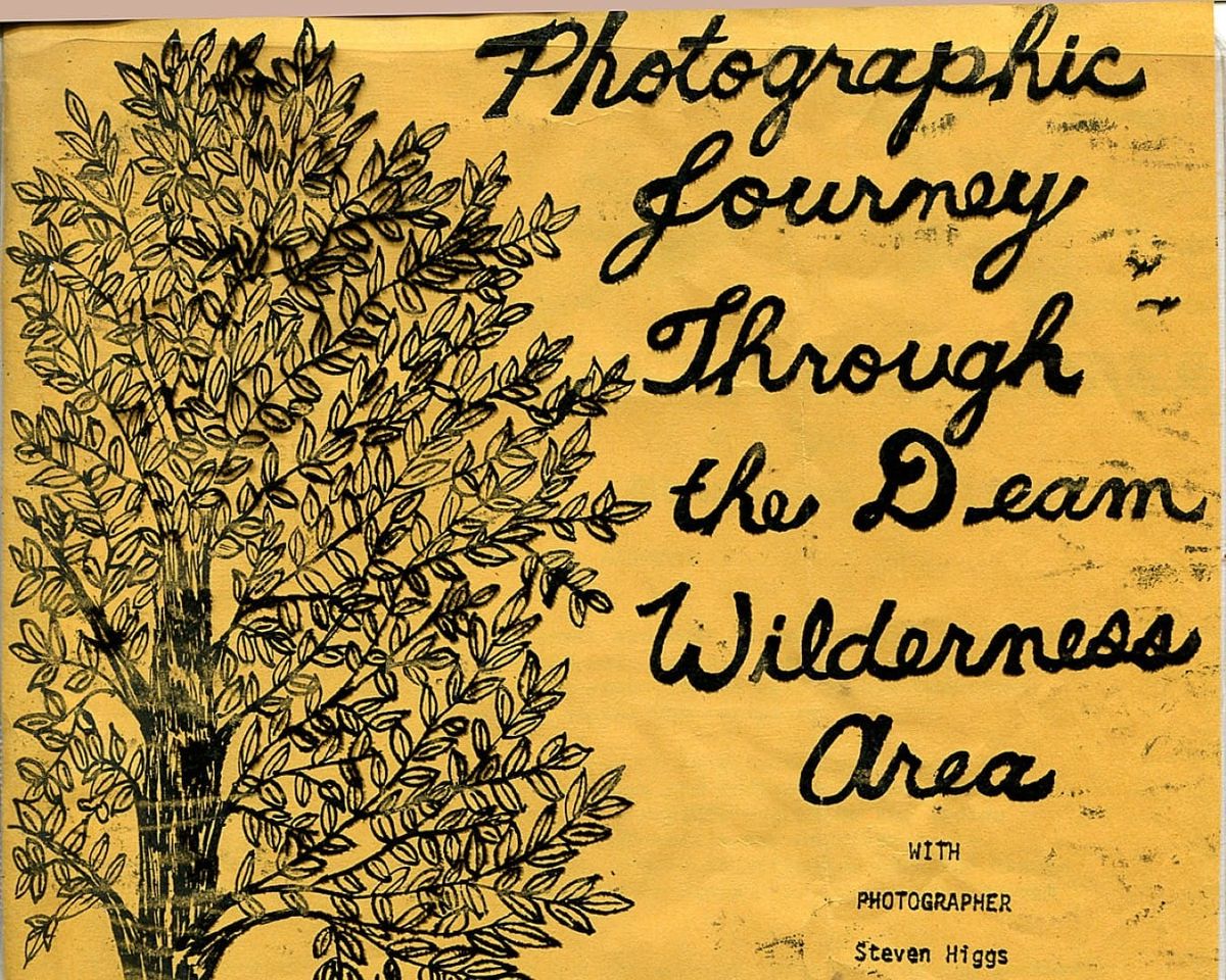 an ink-drawn flier depicting words and a tree on yellowish-brown paper