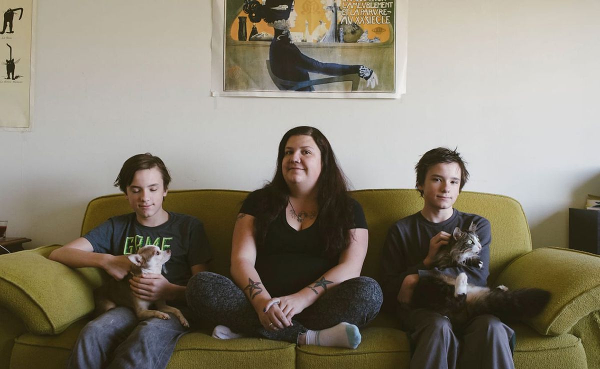 Laura Reagan sits with her twin sons, Korbyn (left) and Jarek, and their dog, Sancho, and cat, Squishy. Reagan has dealt with