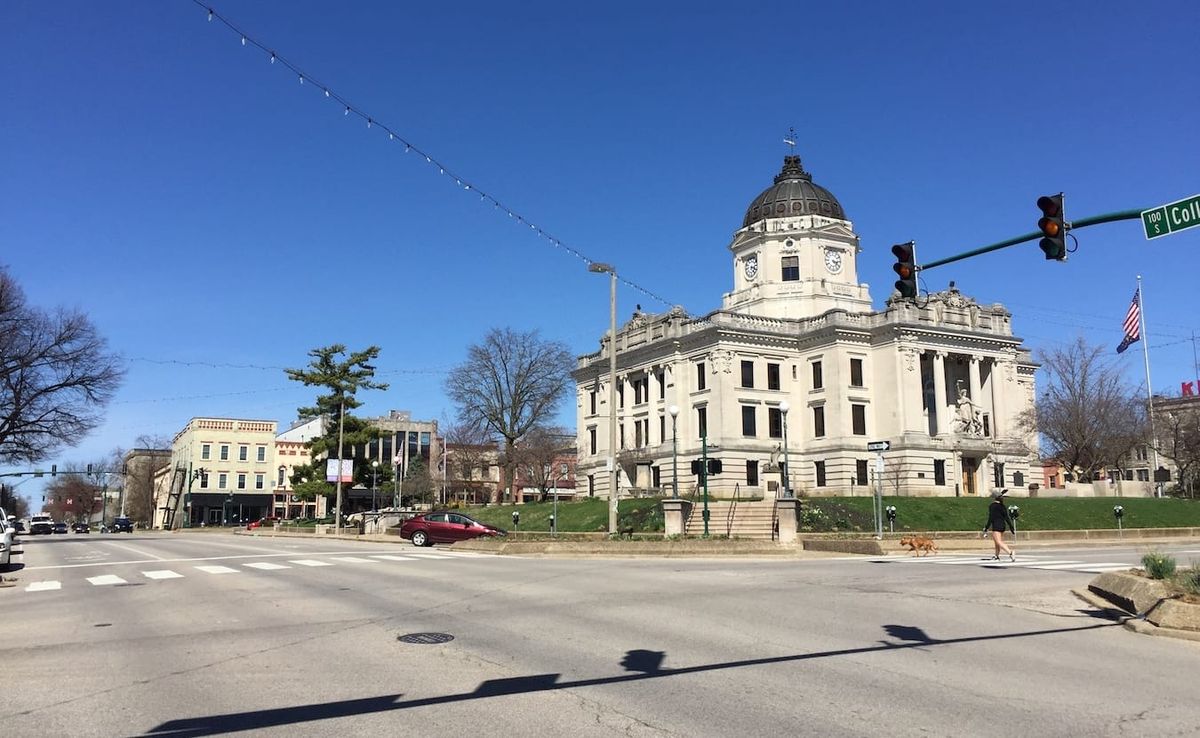 A lone bike rider on the nearly empty streets of Bloomington, Indiana, March 25, 2020. Local officials, organizations, and in