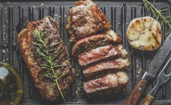 steak and garlic on griddle