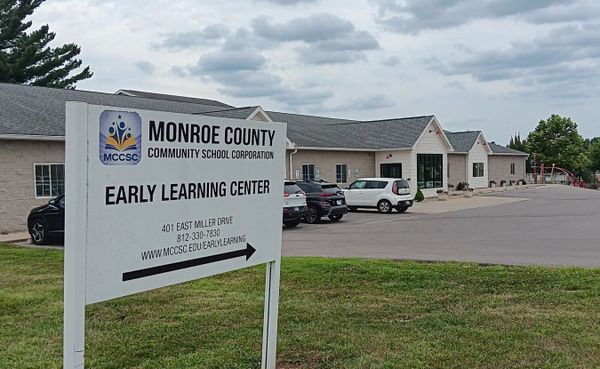 a large white sign for "Monroe County Community School Corporation Early Learning Center, 401 East Miller Drive, 812-330-7830, www.mccsc.edu/earlylearning"