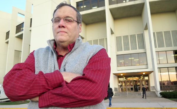 Terry Hutchens stands at the west entrance of Assembly Hall before an Indiana University men's basketball game. After more th