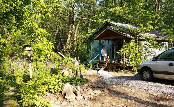 Ann Barlow stands on the porch of her house in Needmore, an intentional community in Brown County, in May 2017. Known in the