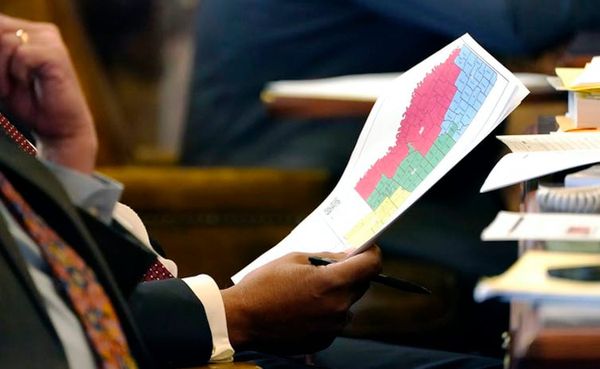 Mississippi State Sen. Joseph Thomas, D-Yazoo City, holds a copy of the proposed congressional redistricting map during debat