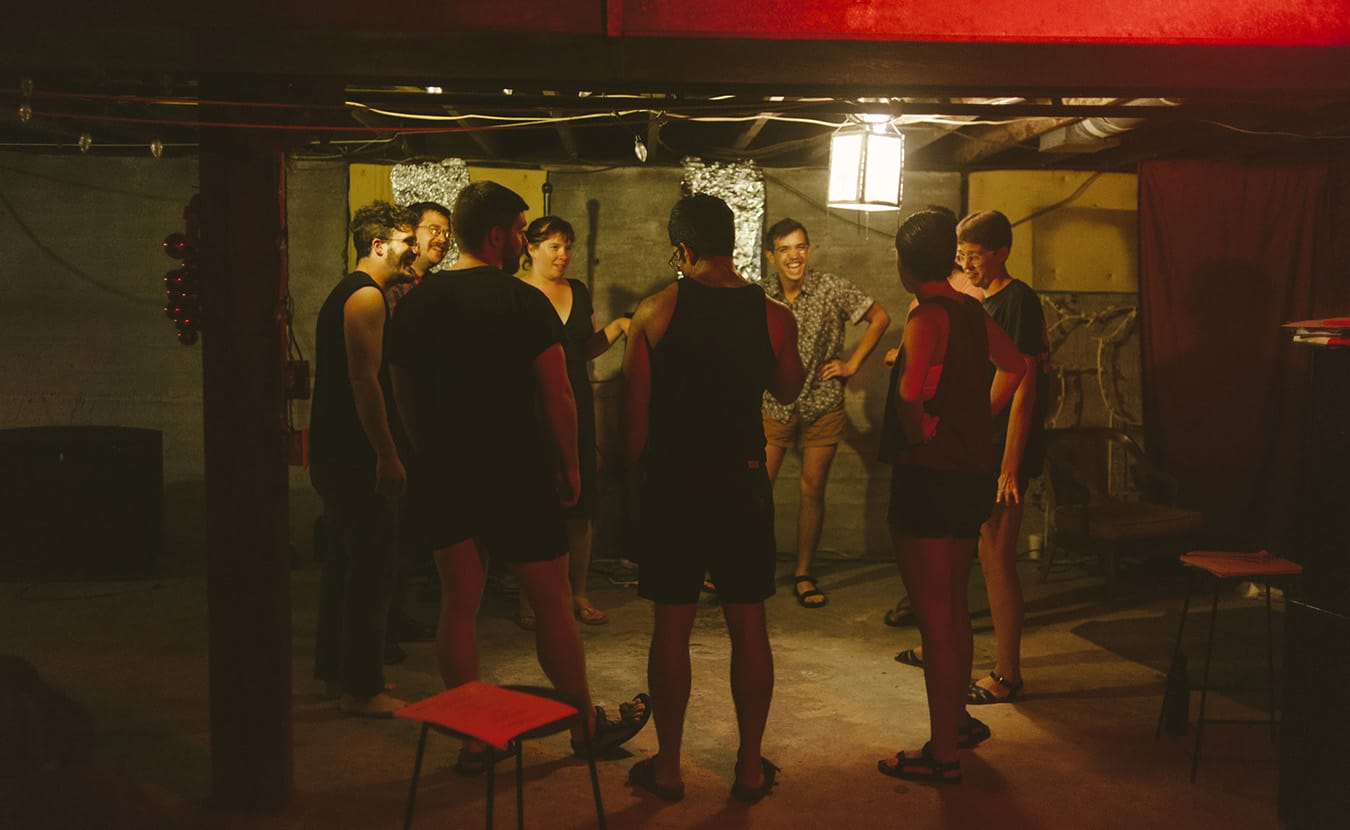 The cast of "Trading Faces" begins rehearsal with a warmup. | Photo by Natasha Komoda