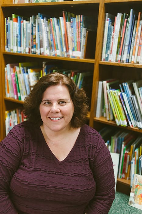 Mary D’Eliso, librarian at University Elementary School, has plenty of suggestions for good summer reads. | Photo by Natasha Komoda