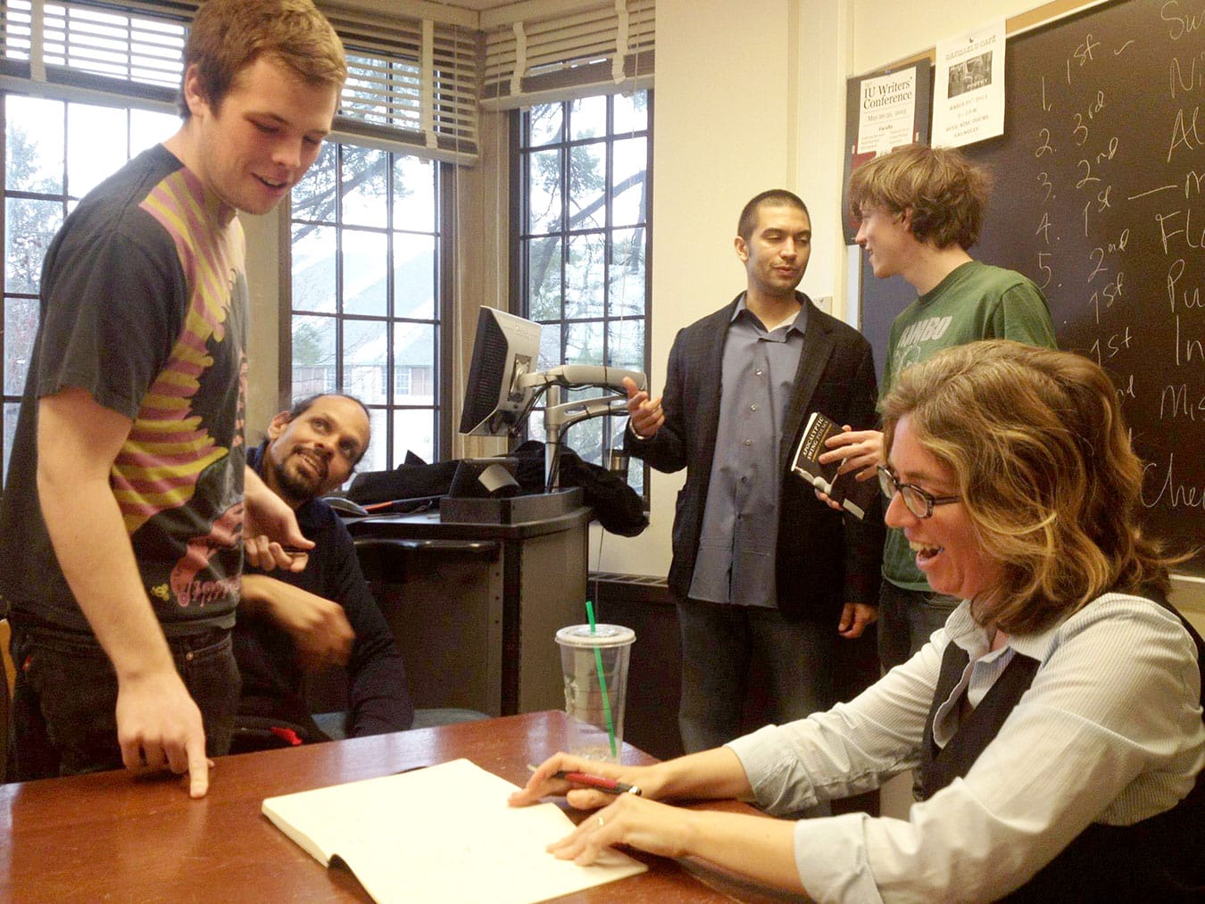 Students Alan Czerwinski (left) and Harlan Kelly (second from right) discuss the craft of writing with poets Ross Gay (second from left) and Gabrielle Calvocoressi (right) in a workshop taught by Indiana University Associate Professor Adrian Matejka (center). | Photo by Zijazo Smith