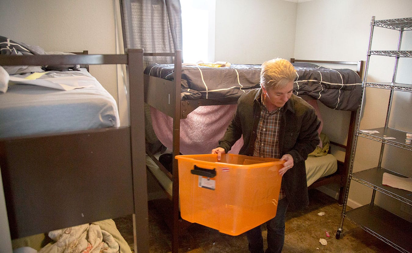 A volunteer organizes a sleeping space at New Hope Family Shelter. | Photo by TJ Jaeger