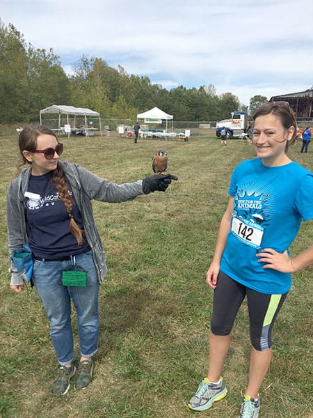 LP sponsored the Run for the Animals to benefit the Monroe County Humane Society. Pictured here, l-r: Carlee LeVasseur of WildCare Inc, Felix the kestrel, and Emily.
