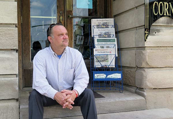 Richey sits on the steps of The Book Corner, which resides in a historic building on the east side of the downtown Square. | Limestone Post