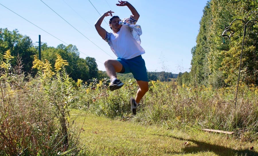 Krista Detor wanted to create “a destination” for artists. “Make it an experience,” she says. “You get writers block or you can’t figure out a riff? Walk out into the woods, sit on a log, dance in the meadow.” Here, theater resident César Pinzón does just that at The Hundredth Hill. | Photo by Grayson Pitts